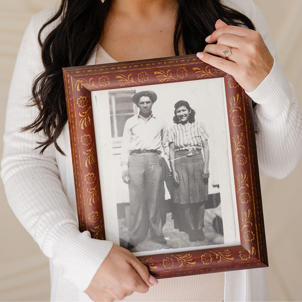 Founder Holding picture of her Grandma and Grandpas Jasso